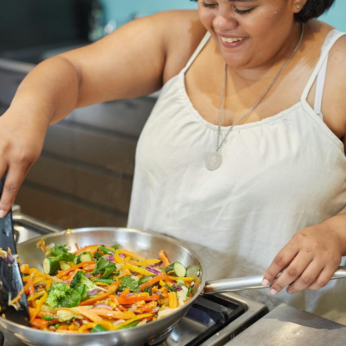 Community members collaborating in a contemporary kitchen, sharing recipes and cooking ideas